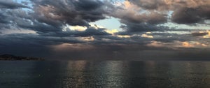 A stormy sky looms over the ocean, filled with dark clouds and rain, symbolizing the challenges of chronic illness.