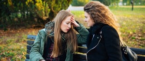 Two women share a moment of closeness, they support each other in difficult times