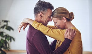 A couple dances closely in a studio, embodying love and resilience in support of the Canadian Cancer Society.