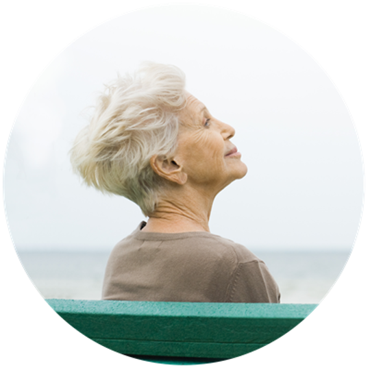 old woman sitting by the sea