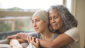 Two women share a heartfelt hug