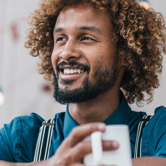 curly man drinks coffee